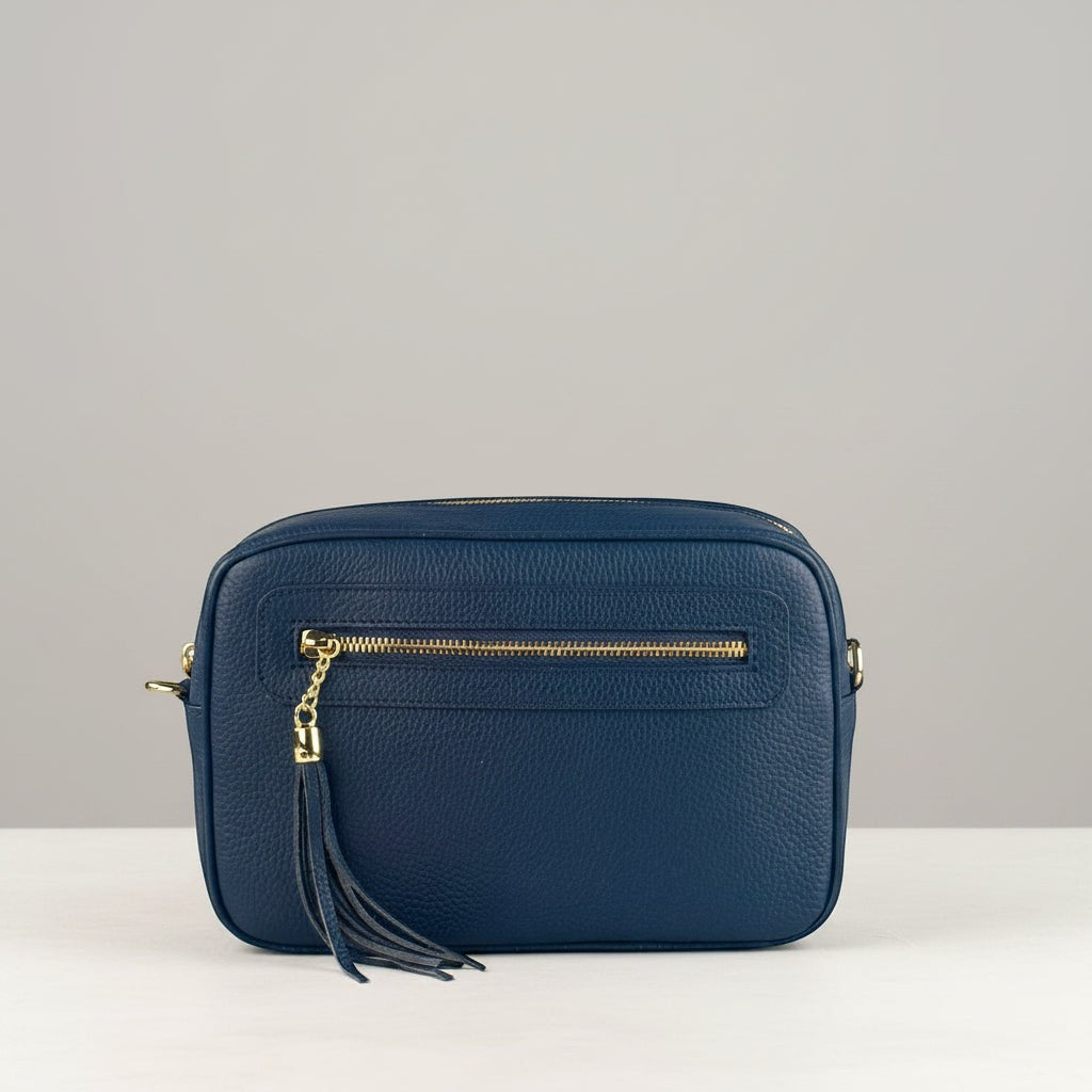Tracollina Pito’s|Bag in vera pelle blu con zip dorata, tracolla rimovibile e nappina decorativa.